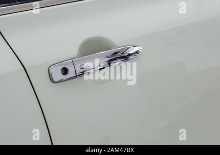 Modern white car door handle.Car door handle is an external part of the car. Stock Photo