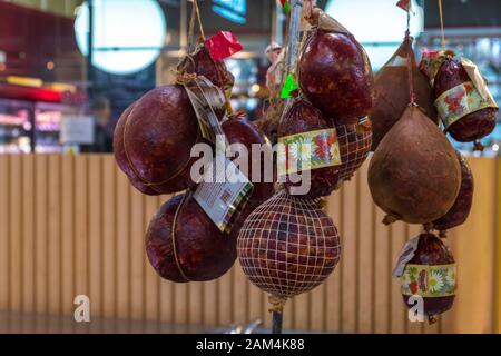 Vilnius, Lithuania - December 15, 2019: Various smoked meats and sausages on the counter at the Market Hall in Vilnius, Lithuania Stock Photo