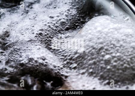 Boiling foam in a saucepan on an electric stove Stock Photo