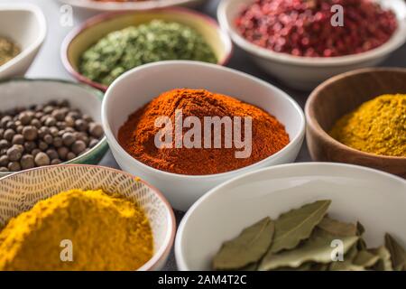 Set of variety aromatic spices and herbs in bowls Stock Photo