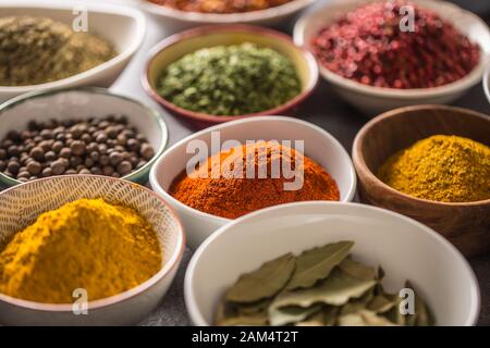 Set of variety aromatic spices and herbs in bowls Stock Photo