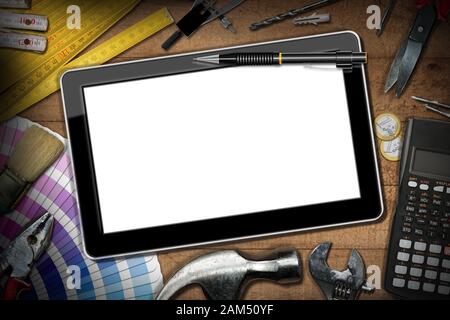 Digital tablet with empty screen on a wooden table with DIY work tools, calculator and Euro currency. Home Improvement concept Stock Photo