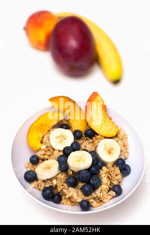 Dish Of Hot Oatmeal With Blueberries And Bananas, Isolated On White 