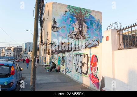 Valparaiso, Chile - August 09, 2019: a street view in Valparaiso with people selling street drink and murales Stock Photo