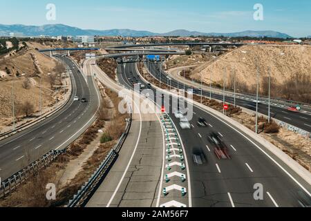 Generic highway overpass long exposure with cars. Captured in outskirts of Madrid, Spain. Deliberate motion blur Stock Photo