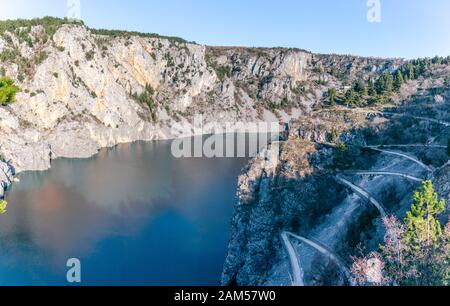 Blue Lake in Imotski, Croatia. Like the nearby Red Lake, it lies in a deep sinkhole formed by the collapse of an enormous cave. Stairs leading to the Stock Photo