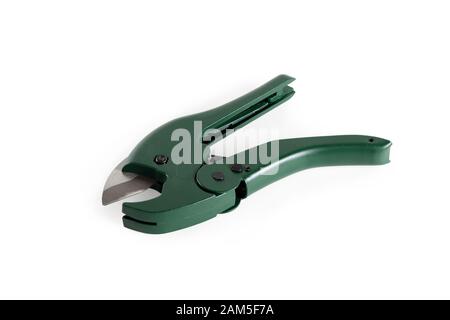 Green pipe cutter for plastic pipes. Close-up. Isolated over white background. Stock Photo