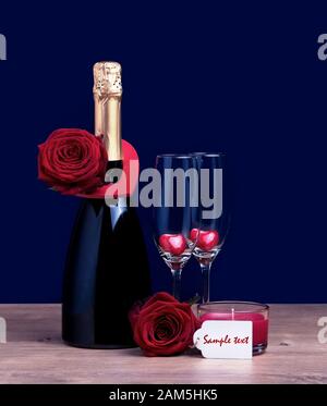 Valentine invitation champagne bottle two glasses with hearts and two roses. International Womens Day March 8 concept. Stock Photo