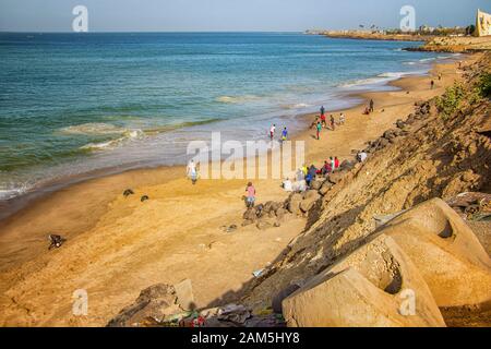 Dakar, Senegal- April 24 2019: Men playing football on the beach near Dakar city in Africa. It is the capital city of Senegal. Stock Photo