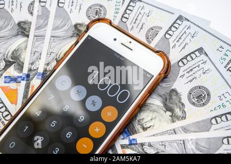 Close-up of Money and Calculator with One thousand on the Display Stock Photo