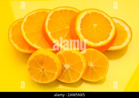 Orange and lemon slices on the yellow background - stock photo Stock Photo