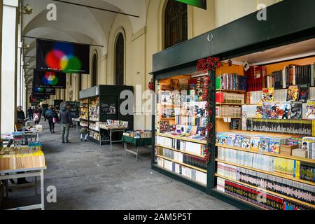Glimpse of the second-hand book market under the arcades of Via Po street in the historic centre of Turin with people in a winter day, Piedmont, Italy Stock Photo