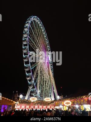 London, England, UK - December 28, 2019: Spinning Ferris wheel at night in winter wonderland in London, in Christmas holiday Stock Photo