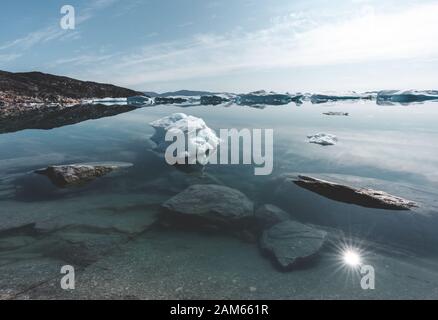 Beautifull landscape with floating icebergs in glacier lagoon and lake in Greenland. Ilulissat Icefjord Glacier. Iceberg and ice from glacier in Stock Photo