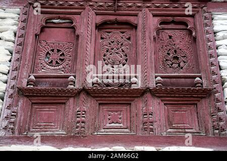Ornate wooden window in Marpha village in Mustang district, Nepal Stock Photo