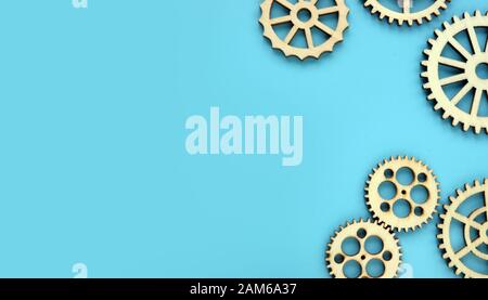 Blue background with wooden gears. Mind works and new ideas concept. Free space. Stock Photo