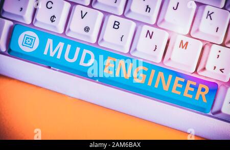 Handwriting text Mud Engineer. Conceptual photo liable for making mixture of fluids used in drilling process White pc keyboard with empty note paper a Stock Photo