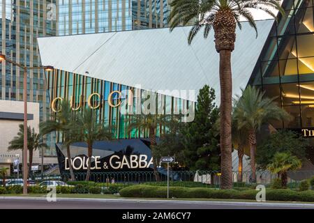 Las Vegas, Nevada, USA- 01 June 2015: Glass skyscraper with exclusive stores, Gucci and Dolce Gabbana. Palm trees in the foreground. World Entertainme
