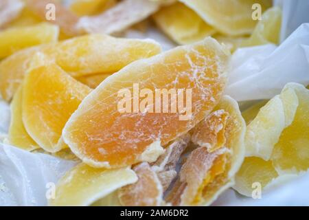 Slices of dried papaya closeup. A delicious dessert for vegetarians. Dried fruits for tea Stock Photo