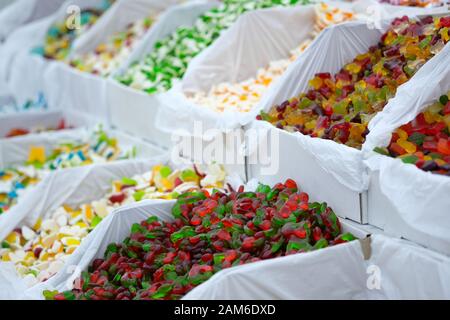 Jelly candies in containers in a store. Large selection of sweets in different colors. Stock Photo