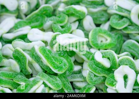 Green jelly sweets top view. White and green sugar jelly rings. Delicious marmalade Stock Photo