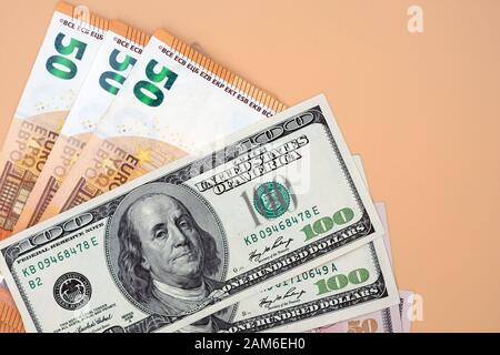 Fifty euro bills and 100 dollars banknotes. Two different currencies. Banknotes background. Stock Photo