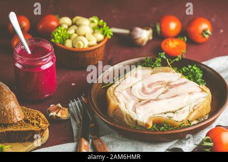 Baking pork lard bacon fatback with black pepper and other herbs and spices in ceramic dish. Traditional Ukrainian, Hungarian, Polish or other Eastern Stock Photo