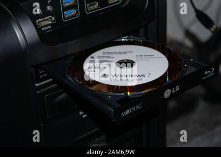 WILDFLECKEN, BAVARIA, GERMANY - JANUARY 11, 2020 An original Microsoft Windows 7 DVD in a DVD drive Stock Photo