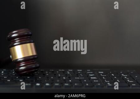 Judge's gavel on computer keyboard on black background with copy space Stock Photo