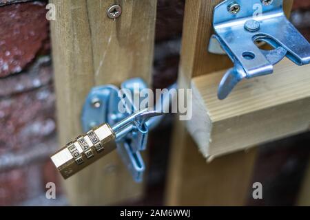 A combination lock on a gate with the focus just on the lock Stock Photo