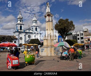 Monument, Iglesia San Felipe Neri, and food vendors on town square in Ipiales, Colombia Stock Photo