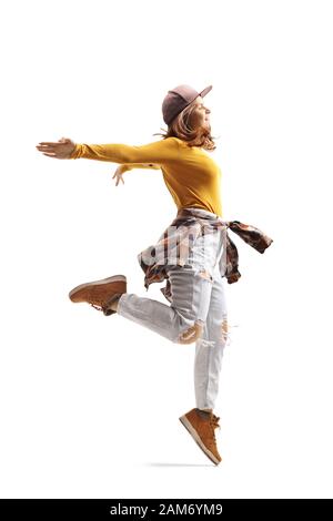 Full length profile shot of a young woman in casual clothes dancing and jumping isolated on white background Stock Photo
