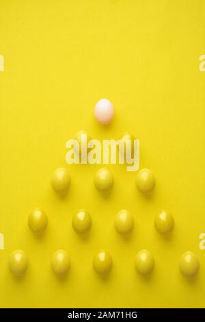 Pattern Of Chicken Eggs In Pyramid Shape Against Yellow Background Stock Photo