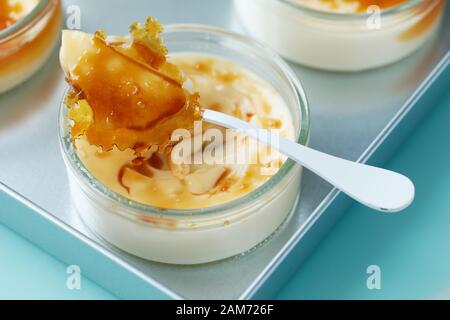 Closeup view of a portion of creme brulee dessert topped with caramelized sugar Stock Photo