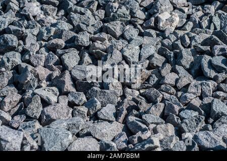 Gray limestone gravel closeup in sunny day Stock Photo