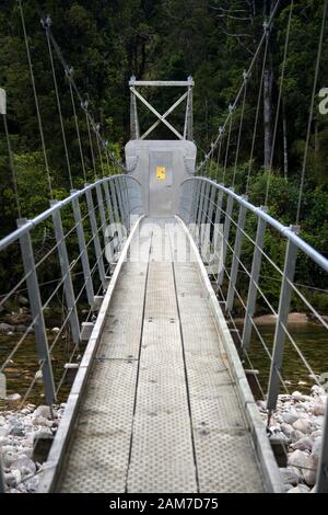 Walking the Old Ghost Road trail, Lyell to Seddonville, New Zealand. Possum proof bridge door on footbridge over the South branch of Mokinhinui river