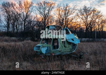 Abandoned broken destroyed old Russian military helicopter. Stock Photo