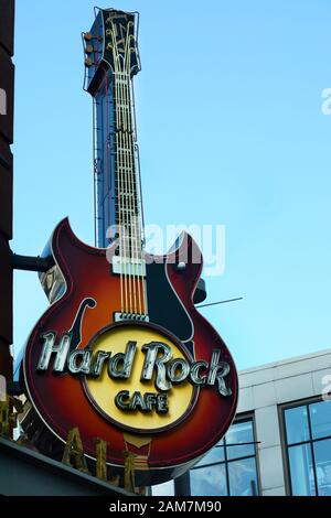 A sign in the shape of a Gibson guitar hangs over the entrance to a Hard Rock Cafe in downtown Denver, Colorado USA Stock Photo