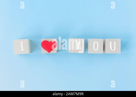 I love you wooden cubes with red heart shape decoration on blue table background and copy space for text. Love, Romantic and Happy Valentines day holiday concept Stock Photo