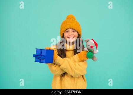 cute santa mice toy gift. small girl hold mouse toy and present box. child knitted clothes play with toy rat. toy shop for kids. christmas is here. xmas favorite winter holiday. happy new 2020 year. Stock Photo