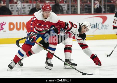 Washington, United States. 11th Jan, 2020. Washington Capitals left wing Jakub Vrana (13) and New Jersey Devils center Nico Hischier (13) battle for a loose puck during the second period at Capital One Arena in Washington, DC on Saturday, January 11, 2020. The Capitals lead the the NHL in points with 65. Photo by Alex Edelman/UPI Credit: UPI/Alamy Live News Stock Photo