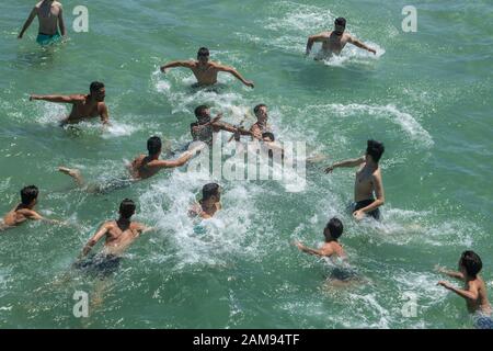 Adelaide, Australia. 12 January 2020. Swimmers dive for the cross  at the   the blessing of the waters on Henley pier marking the orthodox Epiphany Day which commemorates the baptism of Jesus in the Jordan River. Credit: Amer Ghazzal/Alamy Live News Stock Photo
