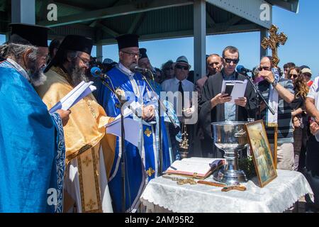 Adelaide, Australia. 12 January 2020.Greek Orthodox clergy perform the ceremony of  the blessing of the waters on Henley pier marking the orthodox Epiphany Day which commemorates the baptism of Jesus in the Jordan River. Credit: Amer Ghazzal/Alamy Live News Stock Photo