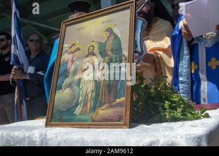 Adelaide, Australia. 12 January 2020. Greek Orthodox clergy  perform the ceremony of  the blessing of the waters on Henley pier Adelaide marking the orthodox Epiphany Day which commemorates the baptism of Jesus in the Jordan River. Credit: Amer Ghazzal/Alamy Live News Stock Photo
