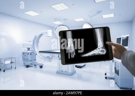 Hand holding x-ray film with 3d rendering mri scan machine or magnetic resonance imaging scan device Stock Photo