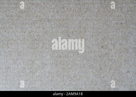 Light brown background from sheet of recycled cardboard. Closeup detail view of abstract texture recycled eco-friendly material pattern background Stock Photo