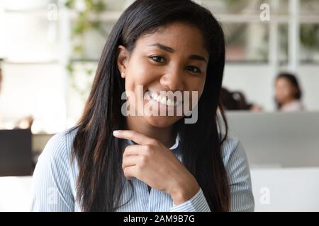 Successful sales manager african woman sitting at workplace closeup portrait Stock Photo