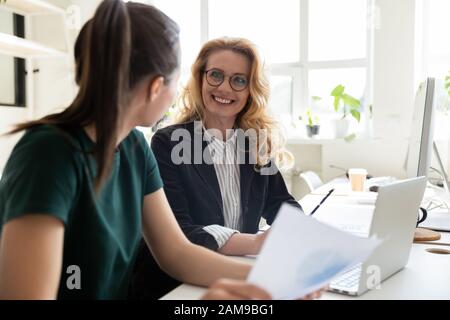 Women workmates working together do statistical analysis using pc app Stock Photo