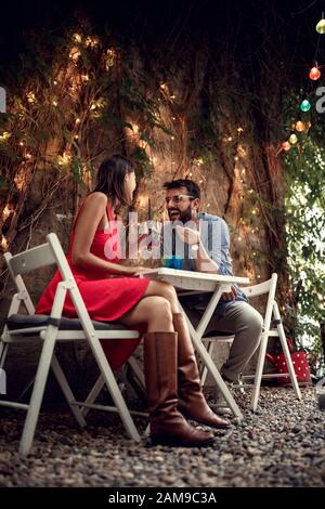 Smiling man and woman in love on a romantic dinner and beverage. Stock Photo