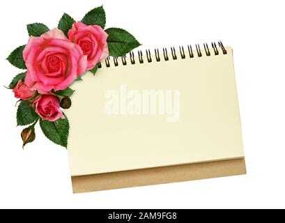 Notebook and rose flowers isolated on white Stock Photo